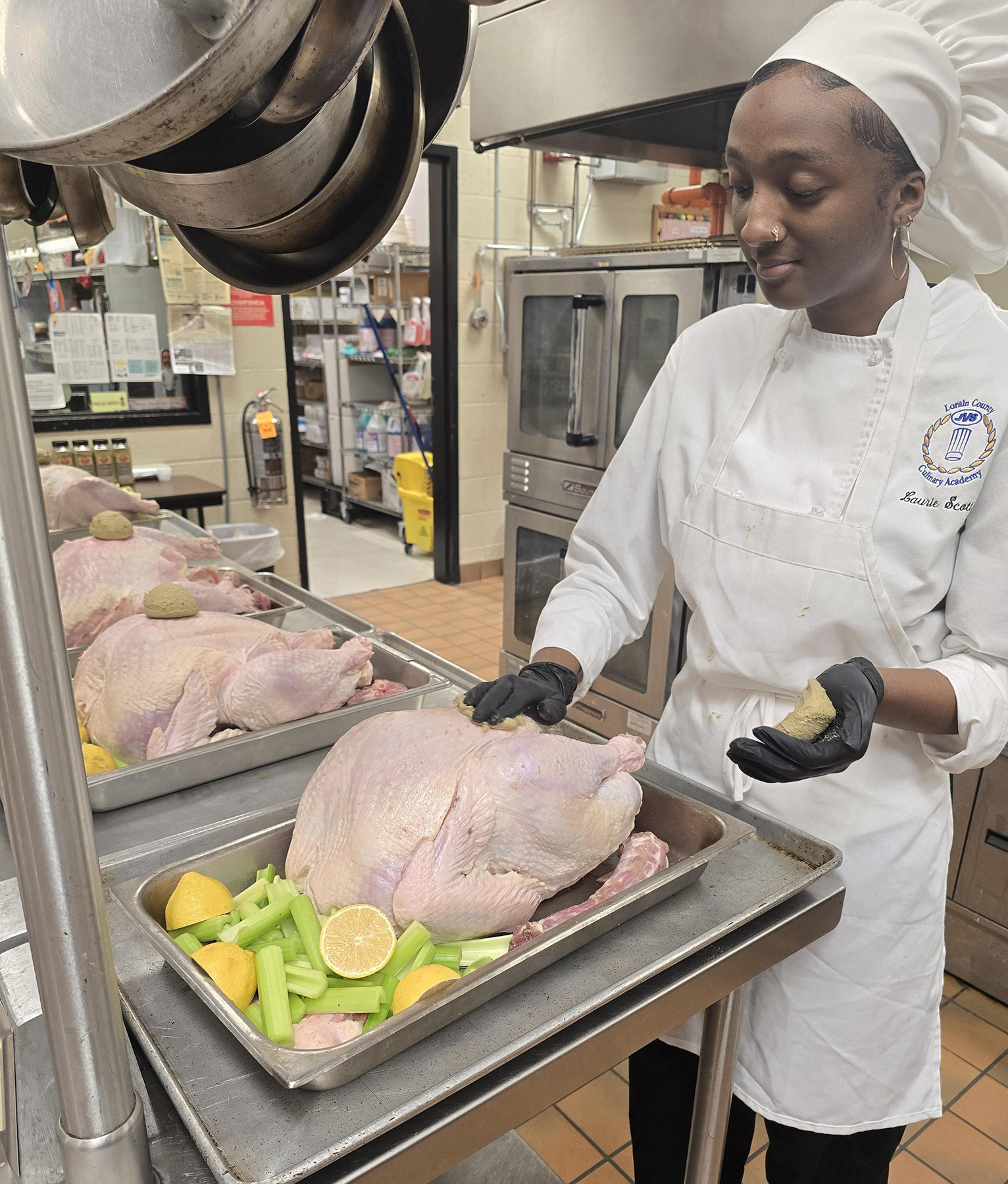 female student prepares turkey